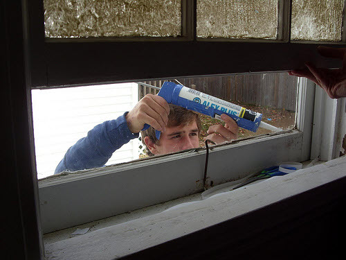caulking a window - one way to make your home more energy efficient