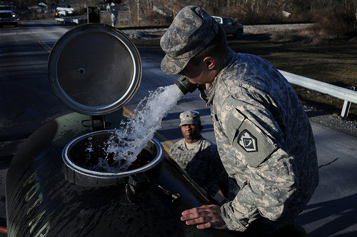 Members of the West Virginia National Guard organize emergency water supplies.